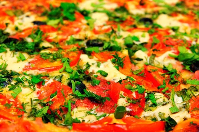 Fast food that made the Close Up View On Pizza With Tomatoes And Greens